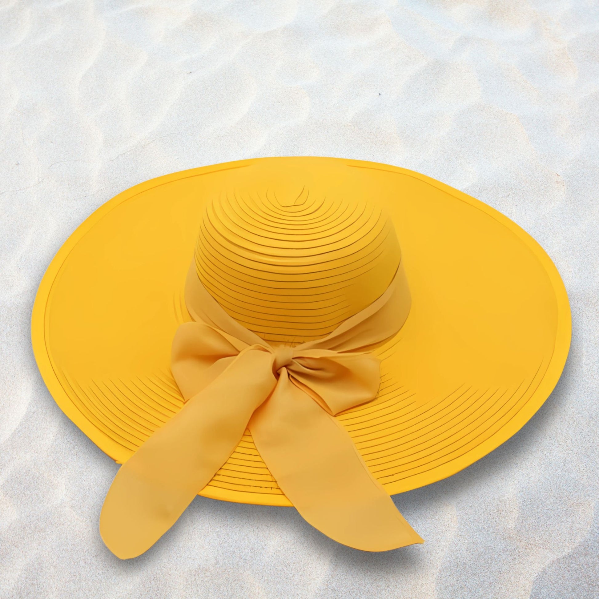 Yellow sun hat with a bow on a textured white background