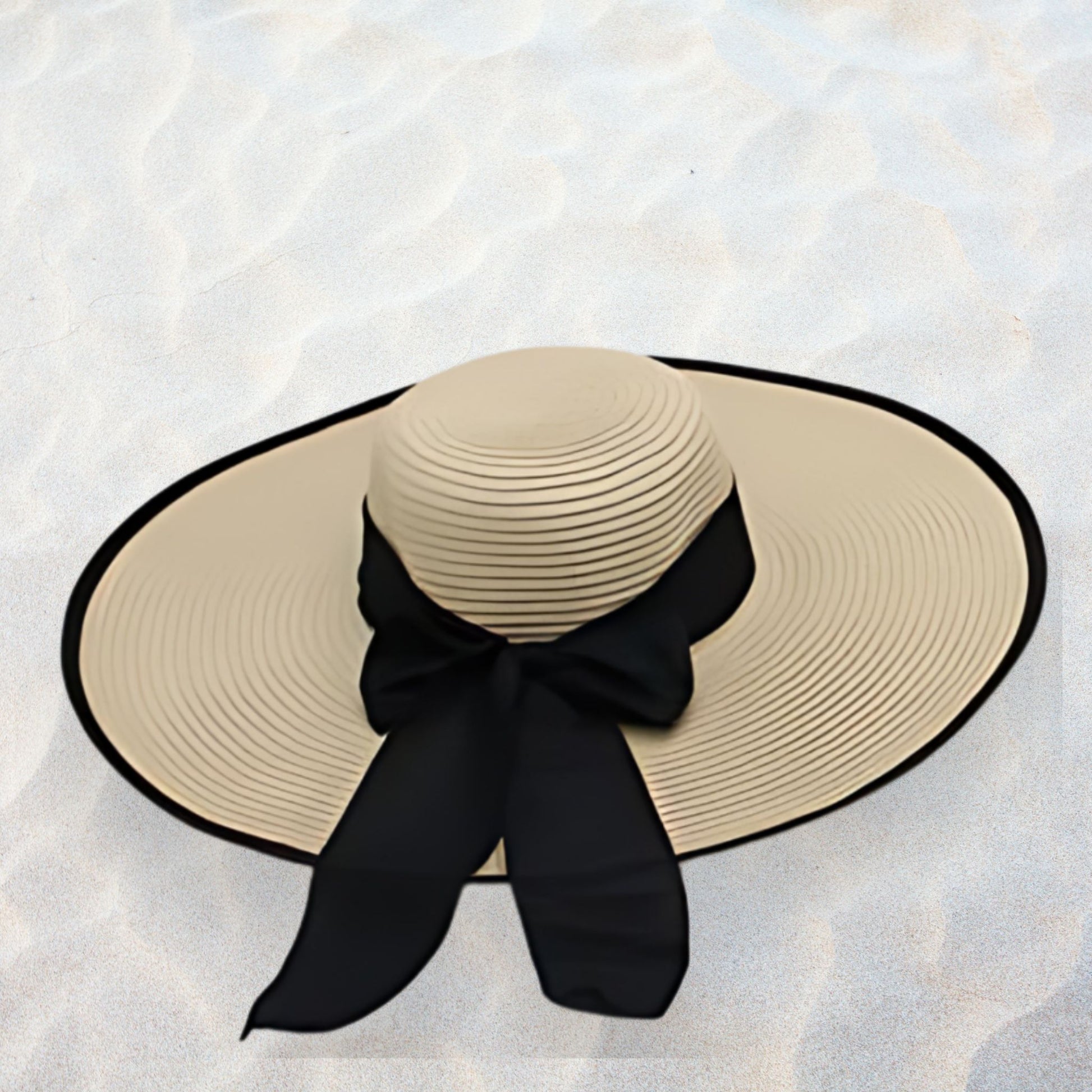 Beige sun hat with a black ribbon on a textured white background
