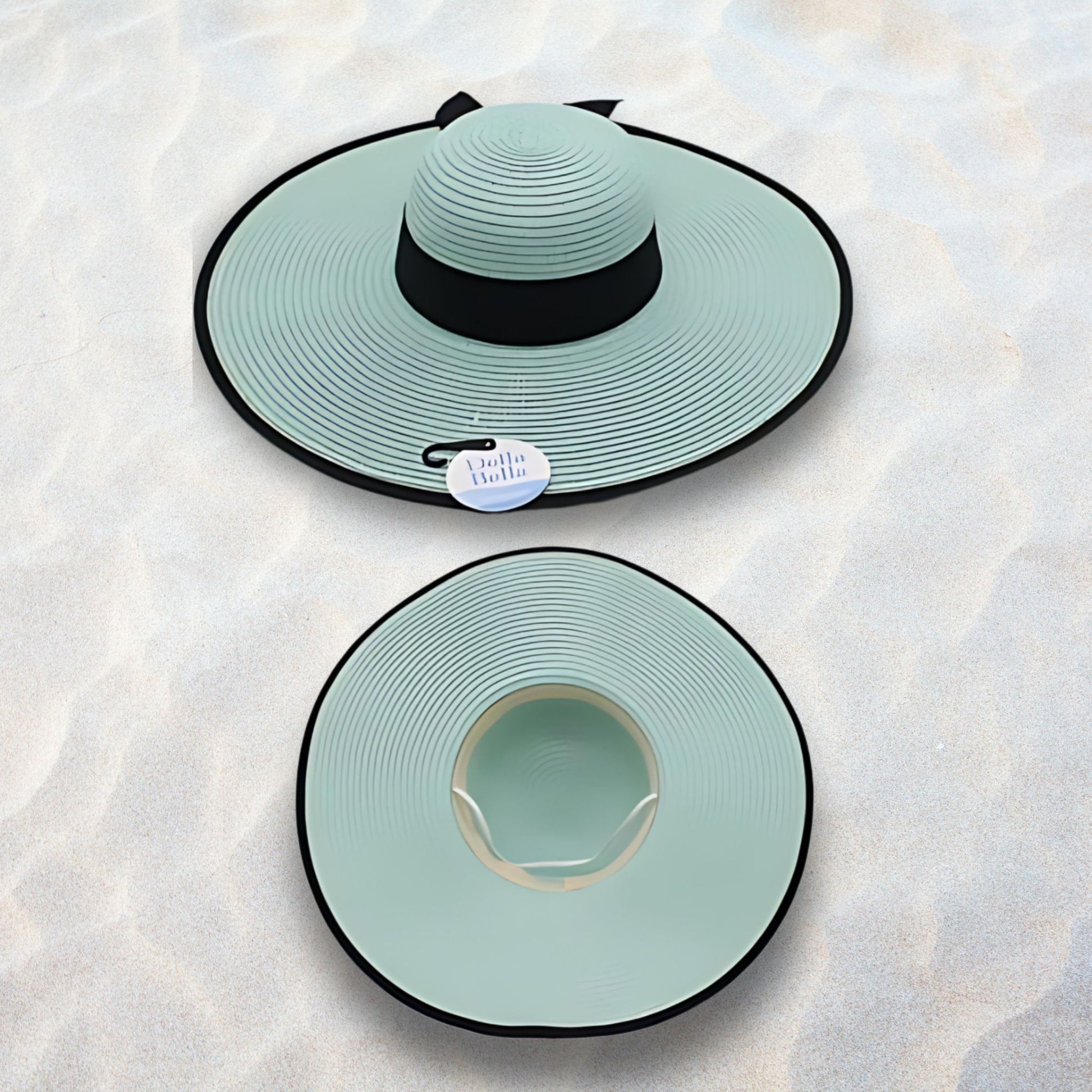 Two light blue sun hats with black brims on a textured white surface
