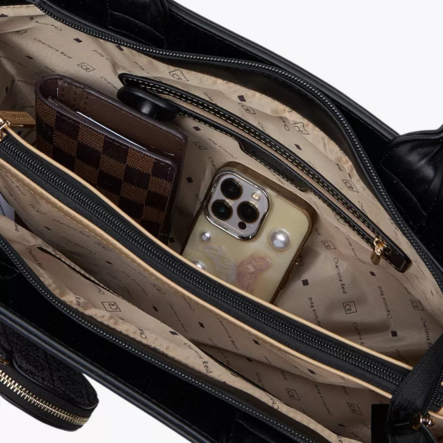 Open suitcase with phone and wallet on a beige interior