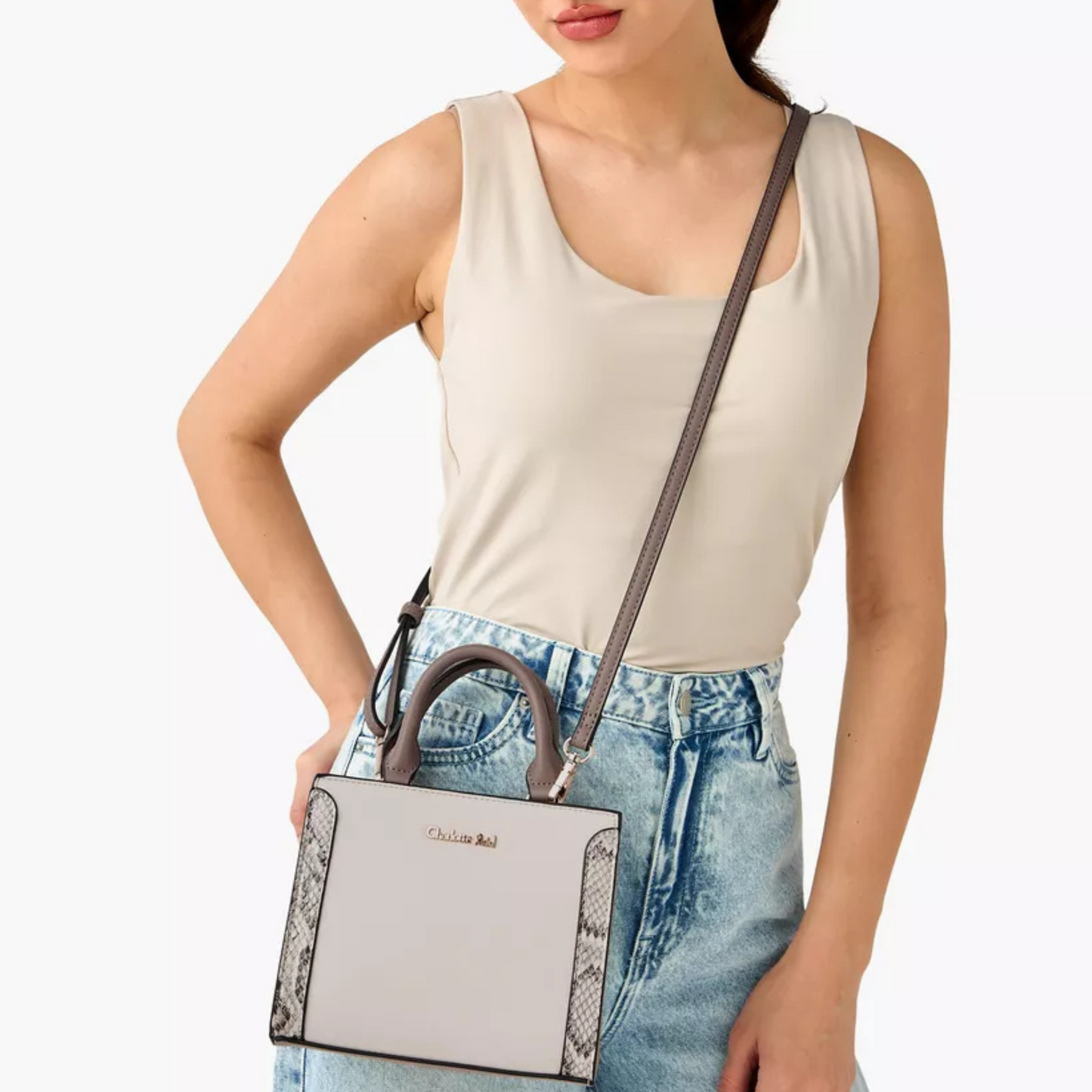 Stylish beige tote with snake-effect trim, zip closure, double handles & crossbody strap. Back slip pocket fits phone, wallet & daily essentials.