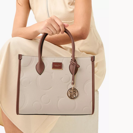 Elegant embossed beige tote bag. Adjustable crossbody strap, roomy interior, and phone/key pocket by InStyle Fashion Hong Kong.