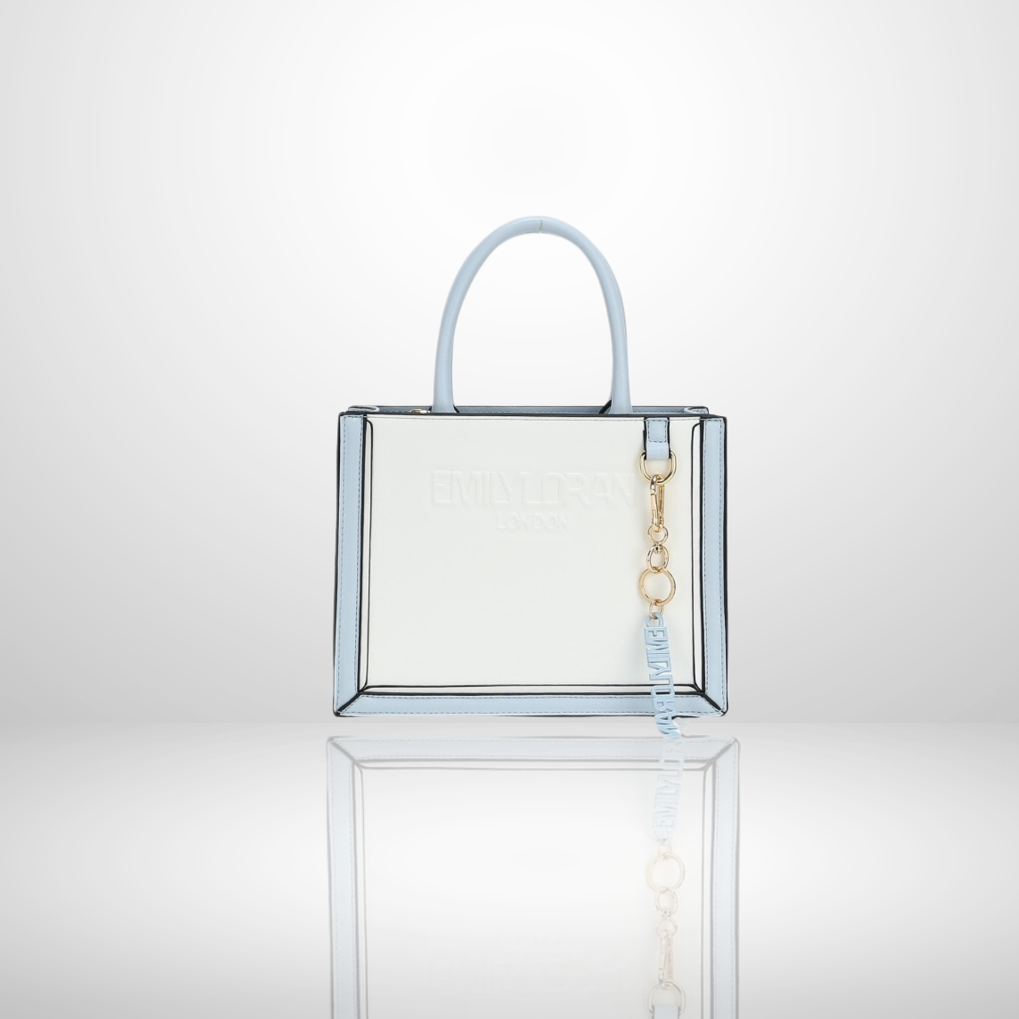 London structured tote bag with premium suede-touch finish, embossed logo, floral print trim, gold-tone hardware, branded charm, and top handles, available in multiple elegant colours.