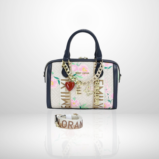 Handbag with floral design and charm, accompanied by a bracelet on a white background