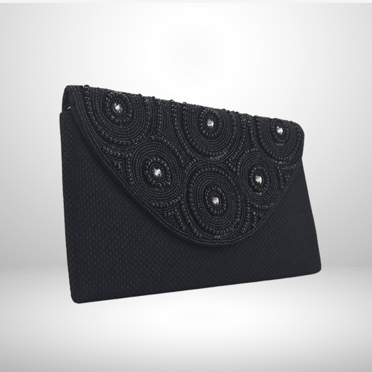 Black beaded clutch bag on a light gray background