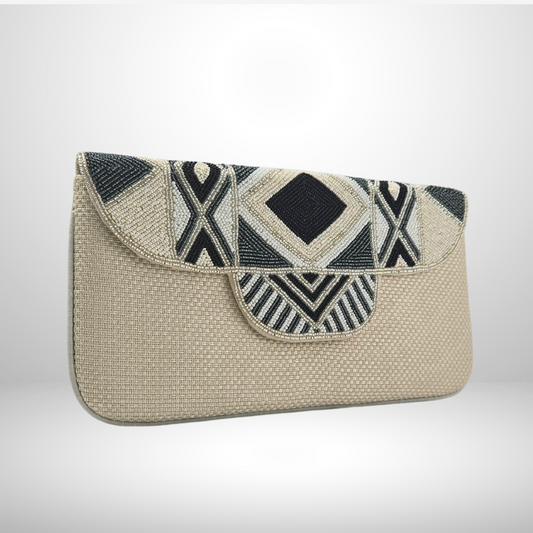 Cream clutch bag with geometric black and white pattern on a light gray background