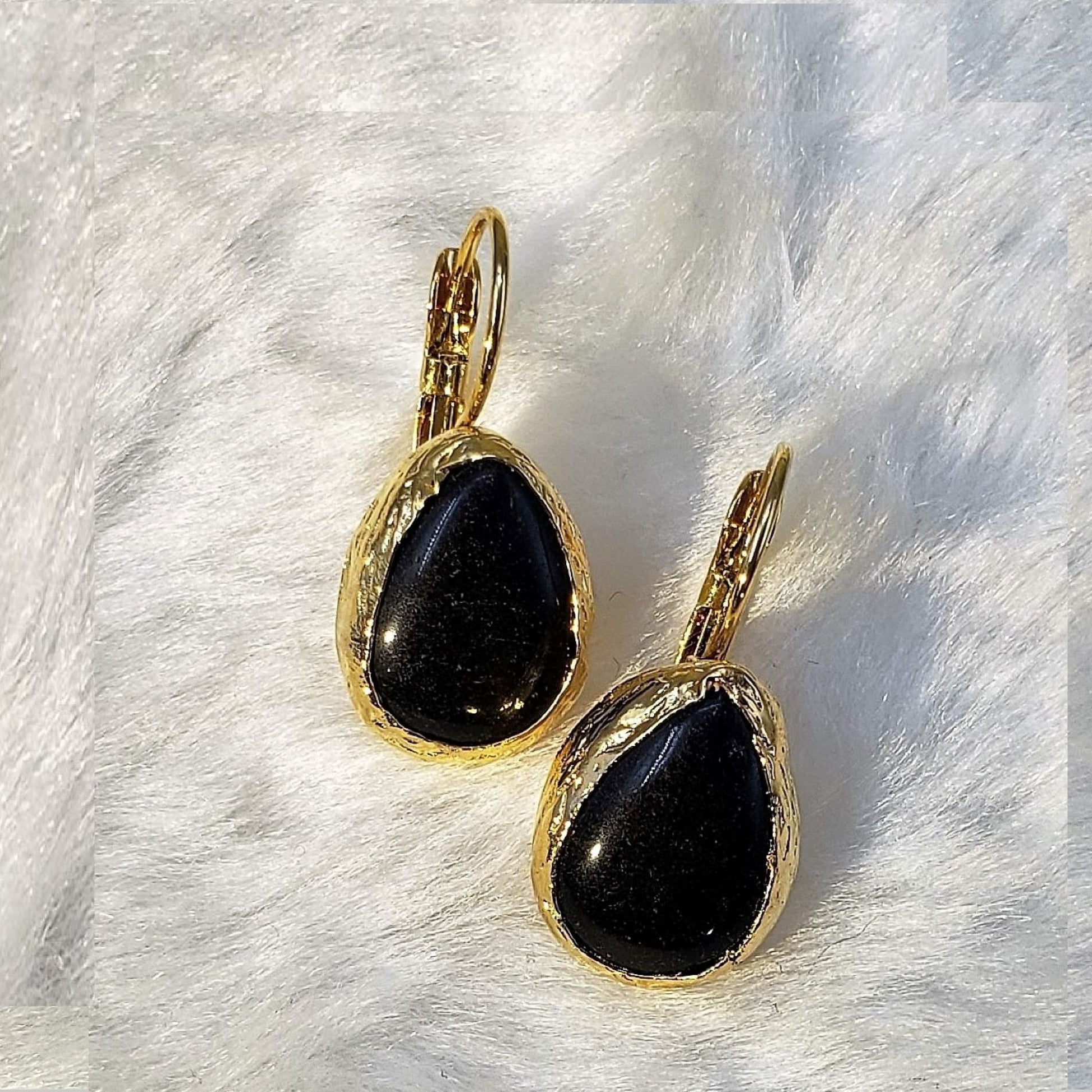 Handcrafted teardrop earrings with 0.5" black onyx stones in 24K gold-plated silver. Each pair is unique with natural gemstone variations.