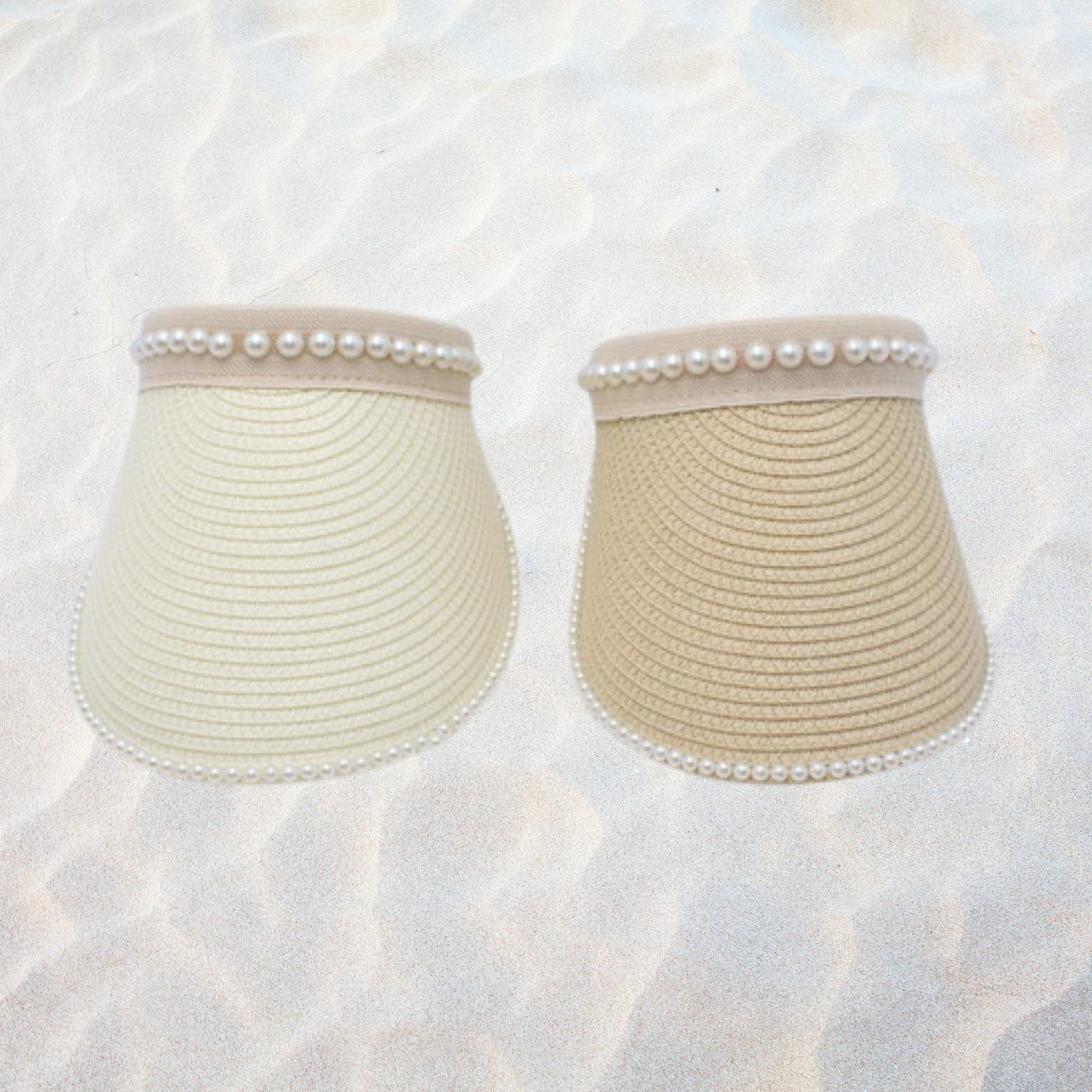Pearl trim straw sun visor hat with wide brim, lightweight woven design, roll-up construction, and elegant pearl embellishments, available in beige, ivory, pink, and camel colors.