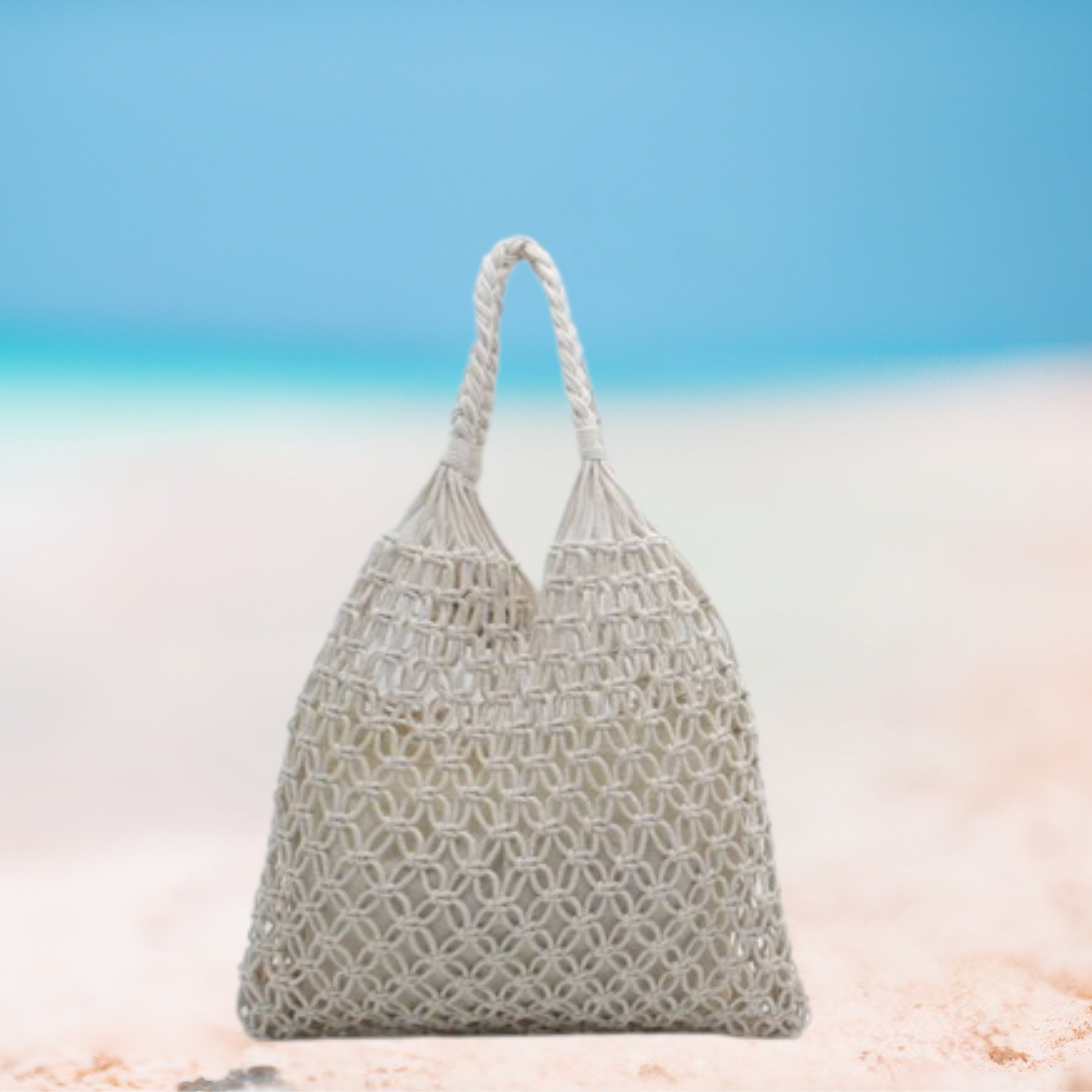 Woven handbag on a beach with a blue sky background