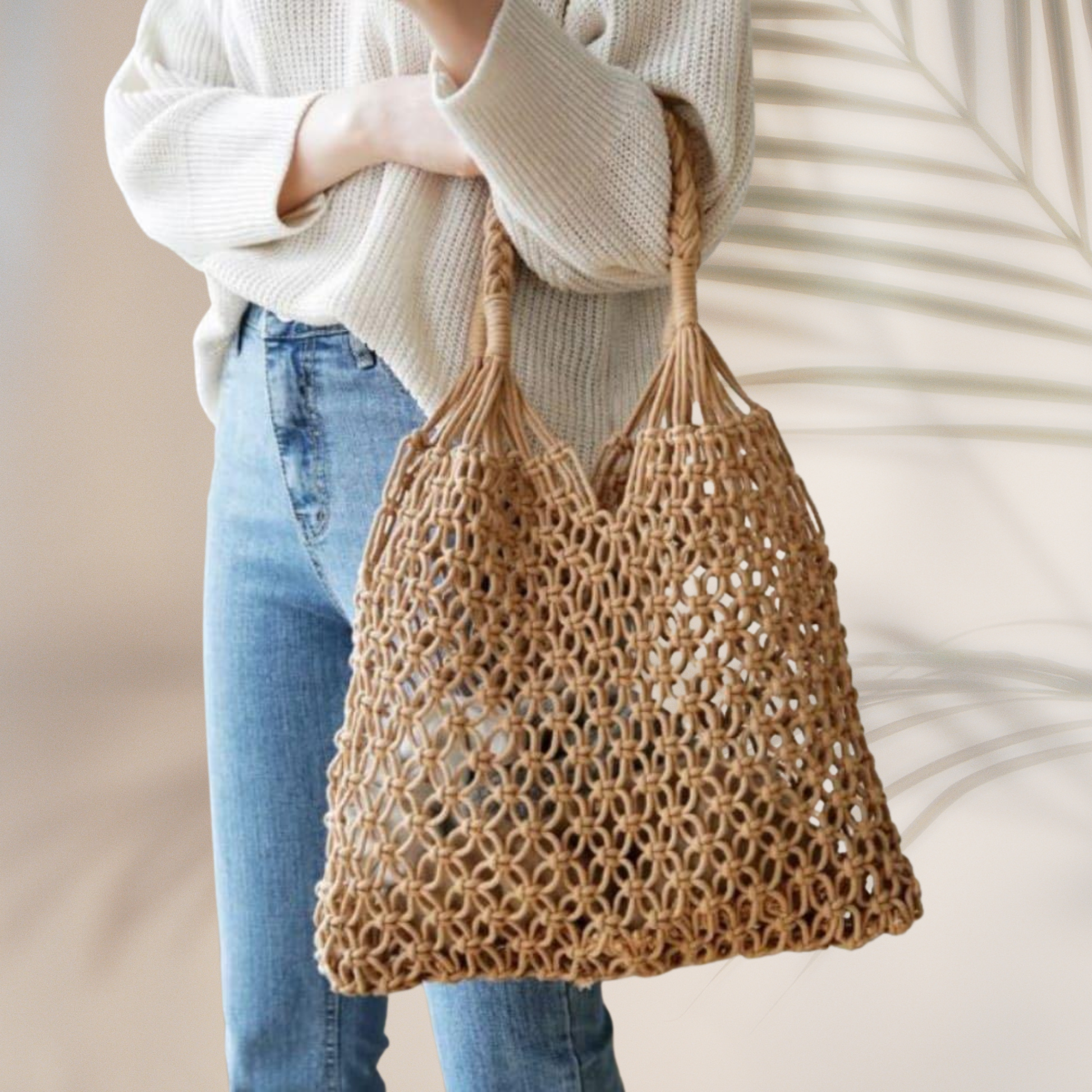 Person holding a woven brown bag with a blurred background