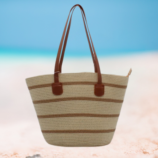 Woven tote bag with brown handles on a beach background