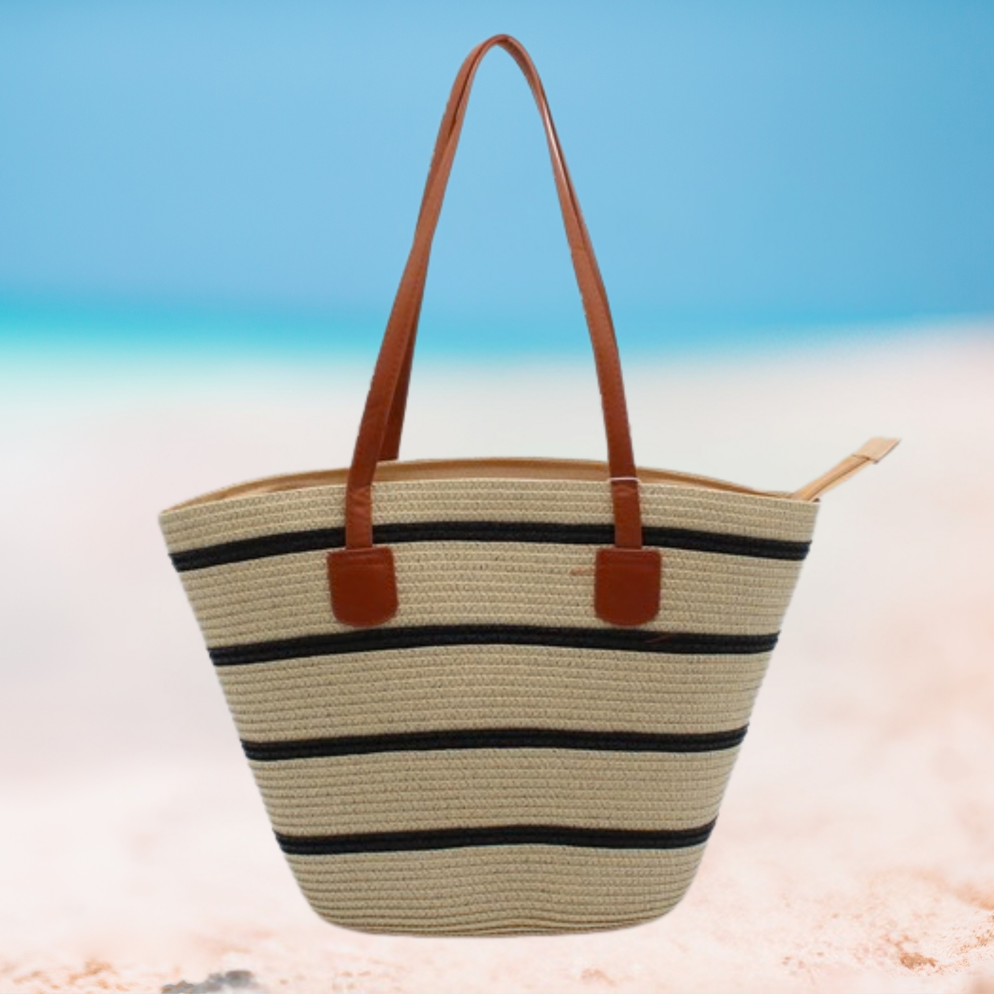 Striped straw tote bag with brown handles on a beach setting