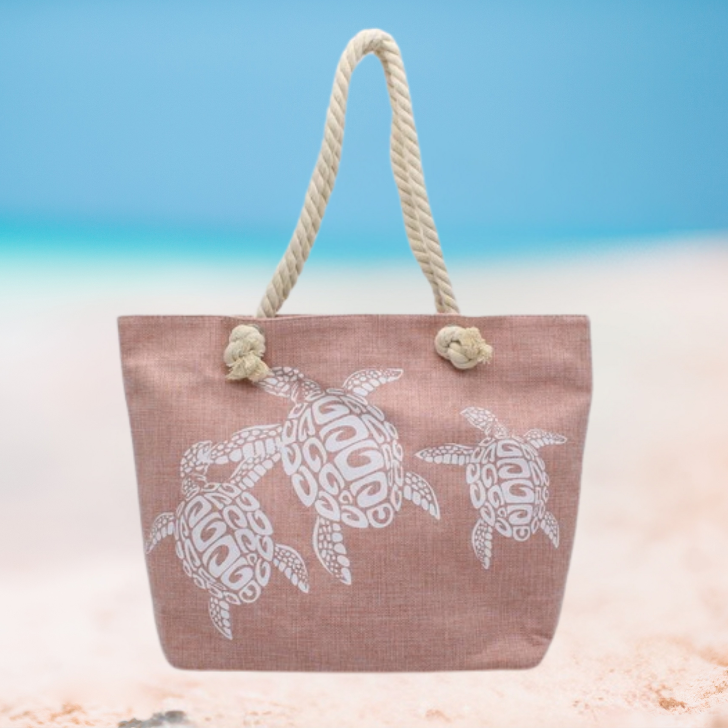 Beach bag with turtle design on a sandy background