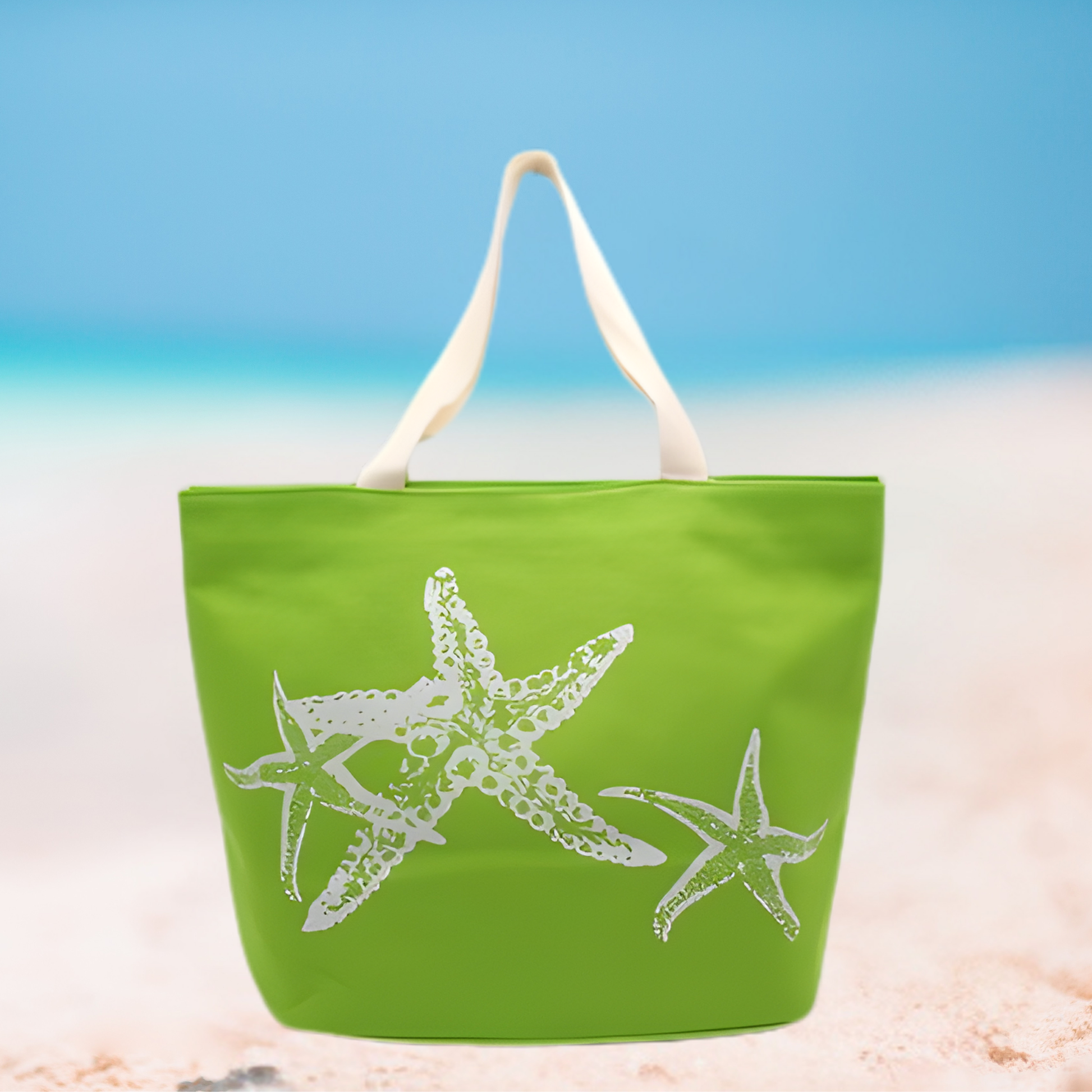 Green tote bag with starfish design on a beach setting