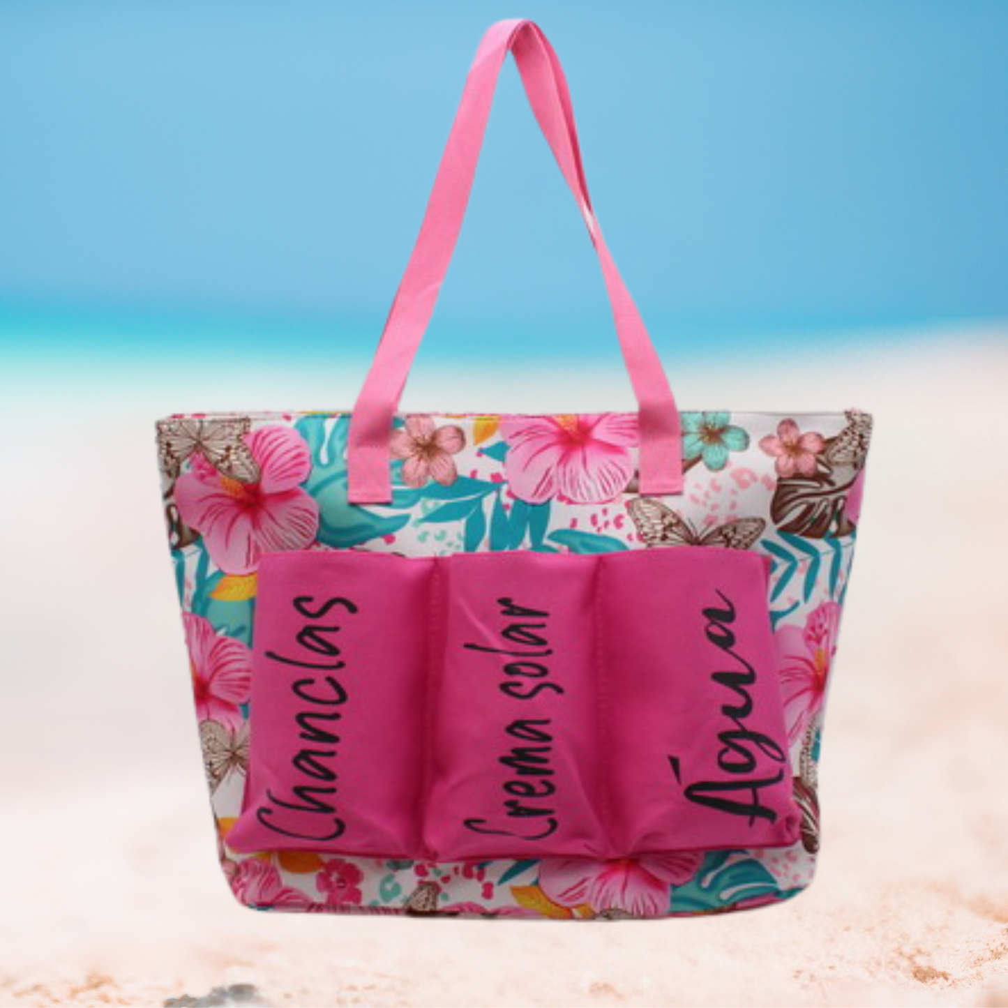 Large floral beach tote bag with labeled front pockets for flip-flops, sunscreen, and water, available in blue, yellow, and pink variations