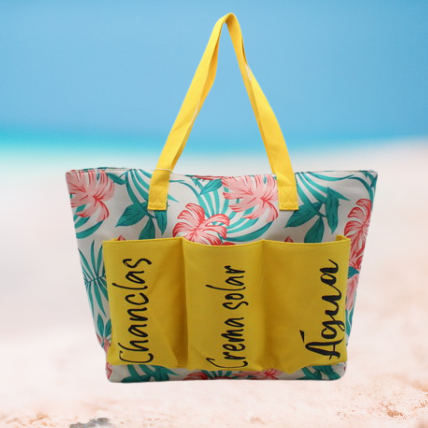 Large floral beach tote bag with labeled front pockets for flip-flops, sunscreen, and water, available in blue, yellow, and pink variations