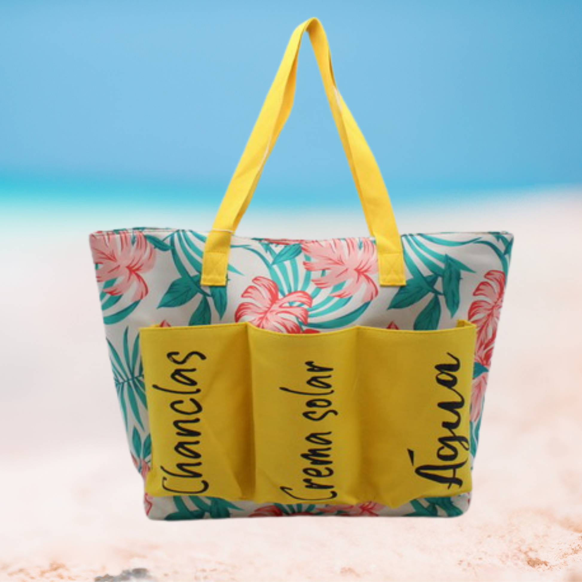 Large floral beach tote bag with labeled front pockets for flip-flops, sunscreen, and water, available in blue, yellow, and pink variations