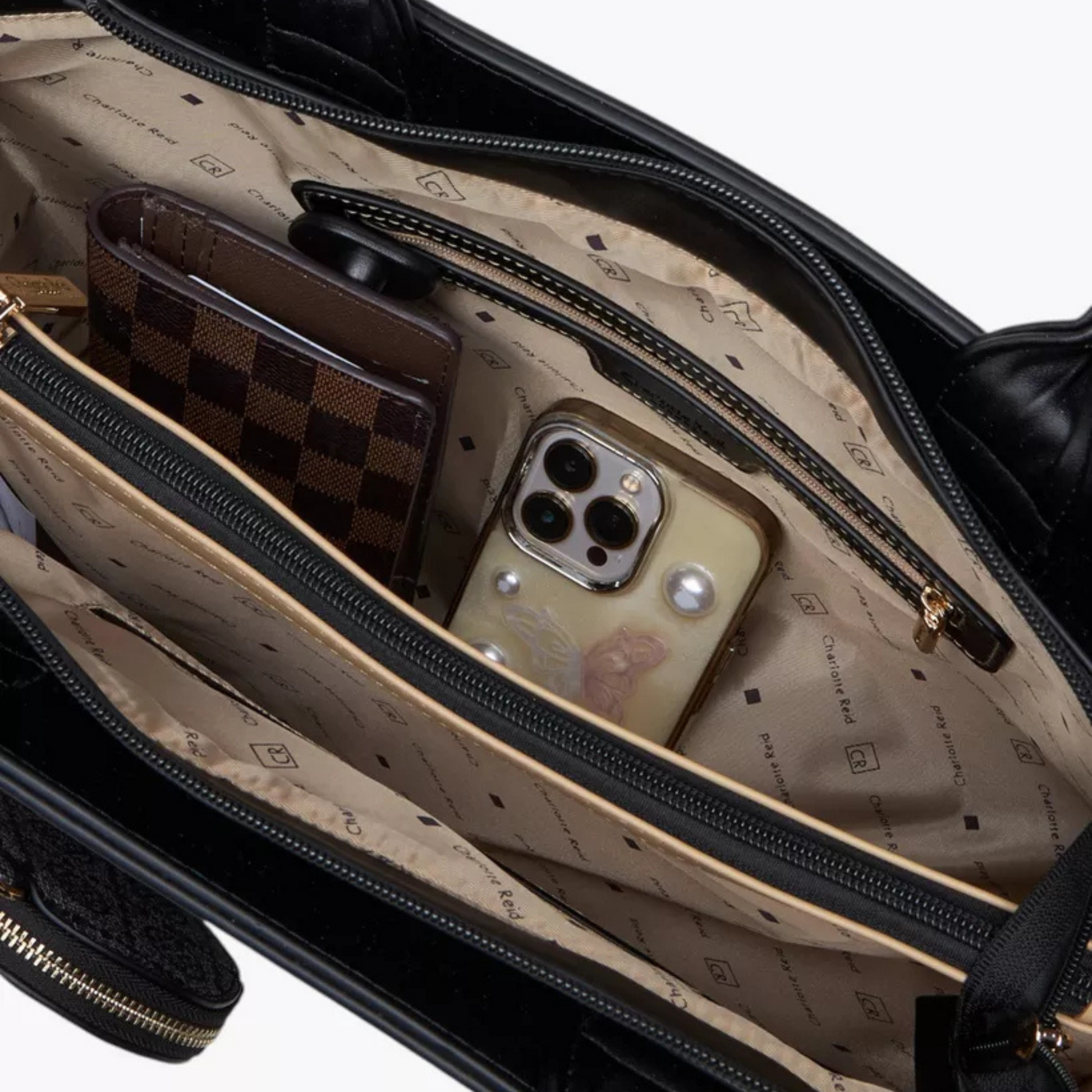 Open suitcase with phone and wallet on a beige interior