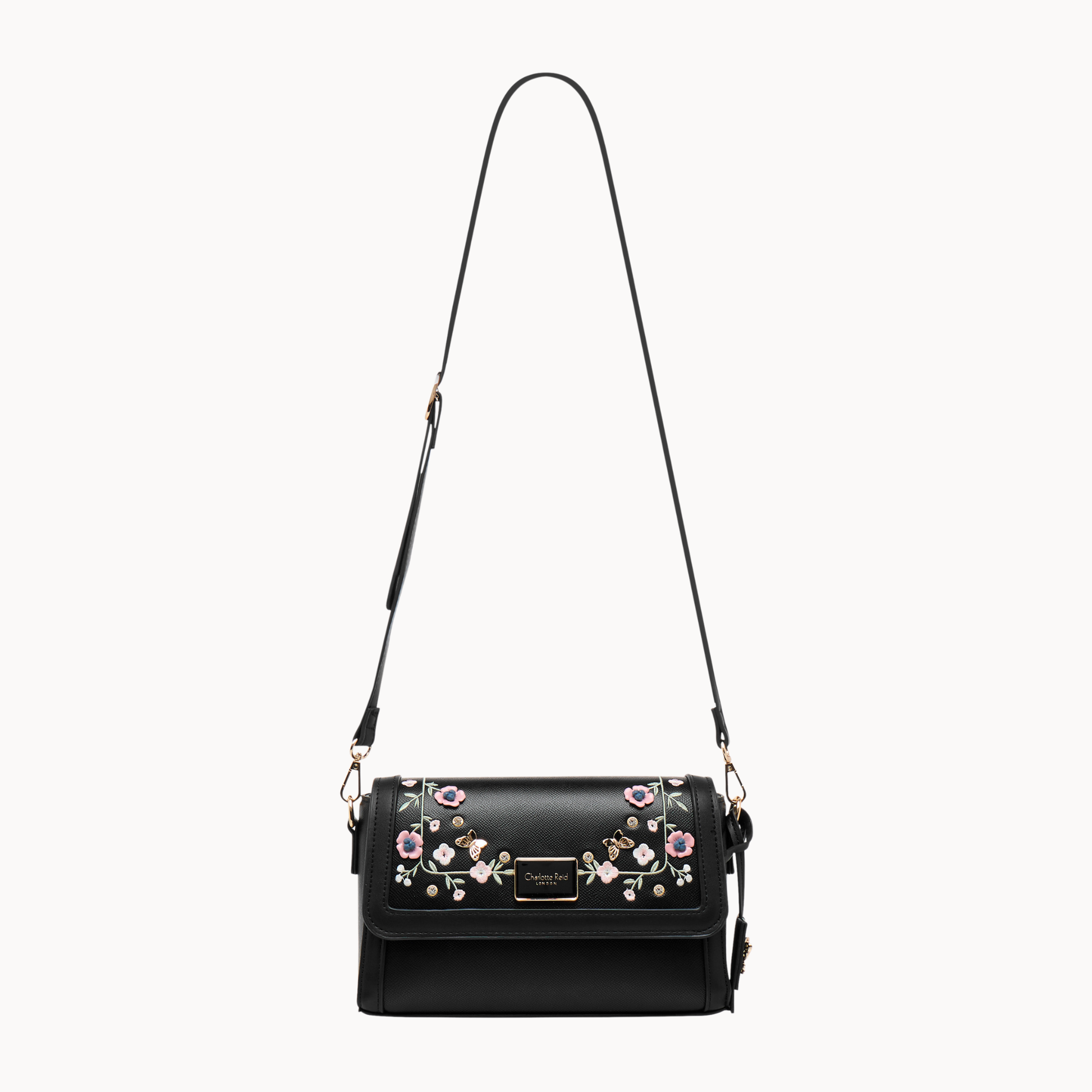 embroidered black floral crossbody bag in vegan leather. Features high-quality gold hardware & adjustable strap. Perfect for chic, everyday style.