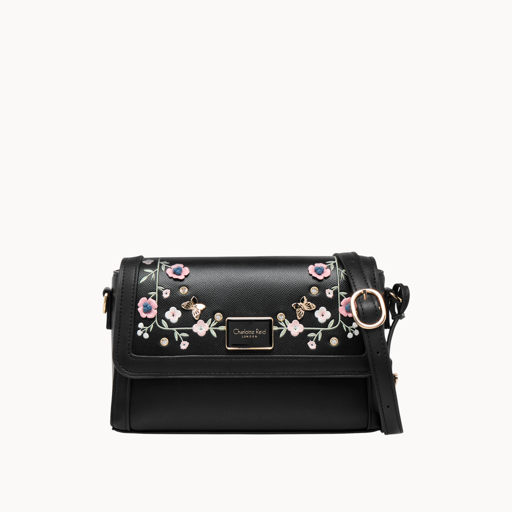 embroidered black floral crossbody bag in vegan leather. Features high-quality gold hardware & adjustable strap. Perfect for chic, everyday style.