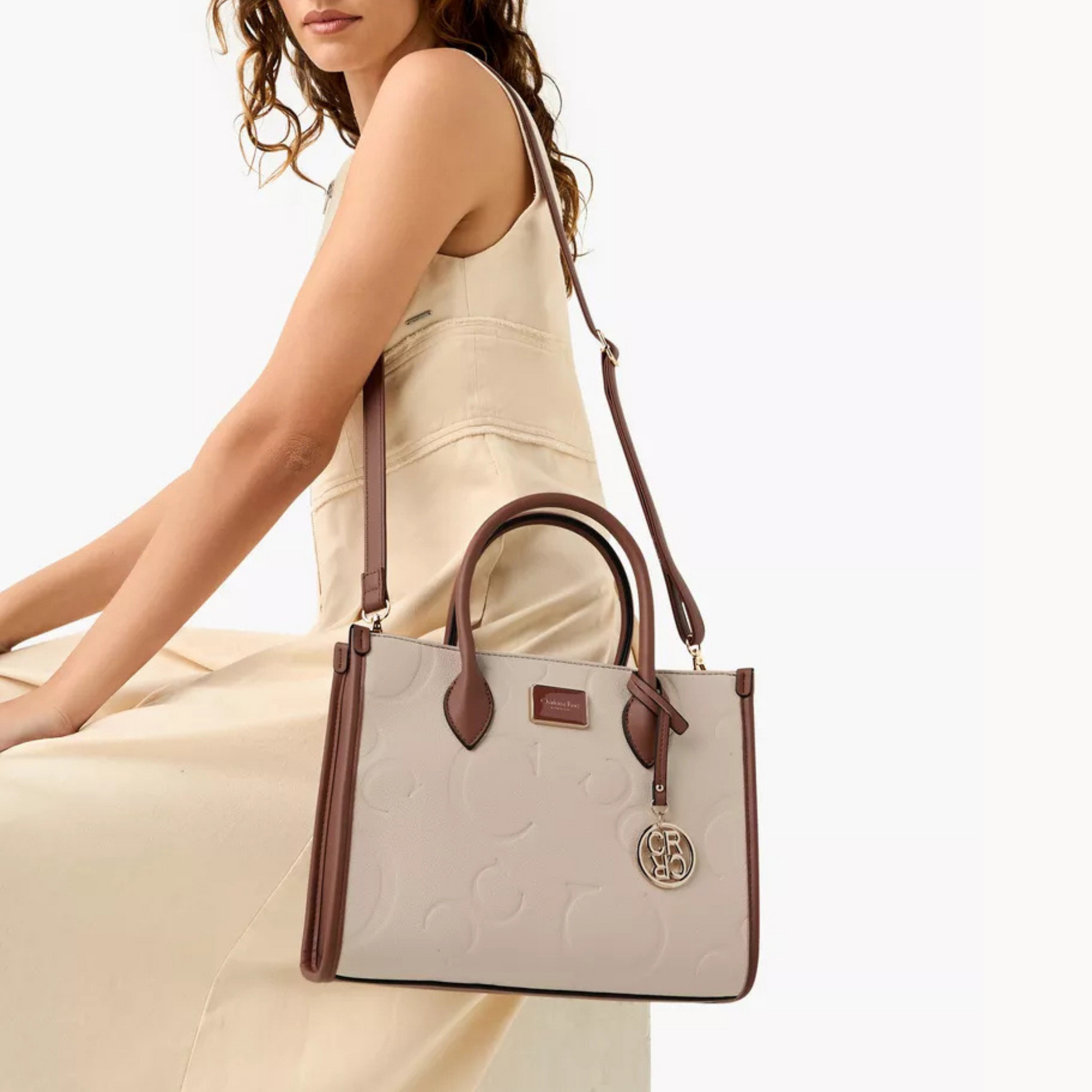 Elegant embossed beige tote bag. Adjustable crossbody strap, roomy interior, and phone/key pocket by InStyle Fashion Hong Kong.
