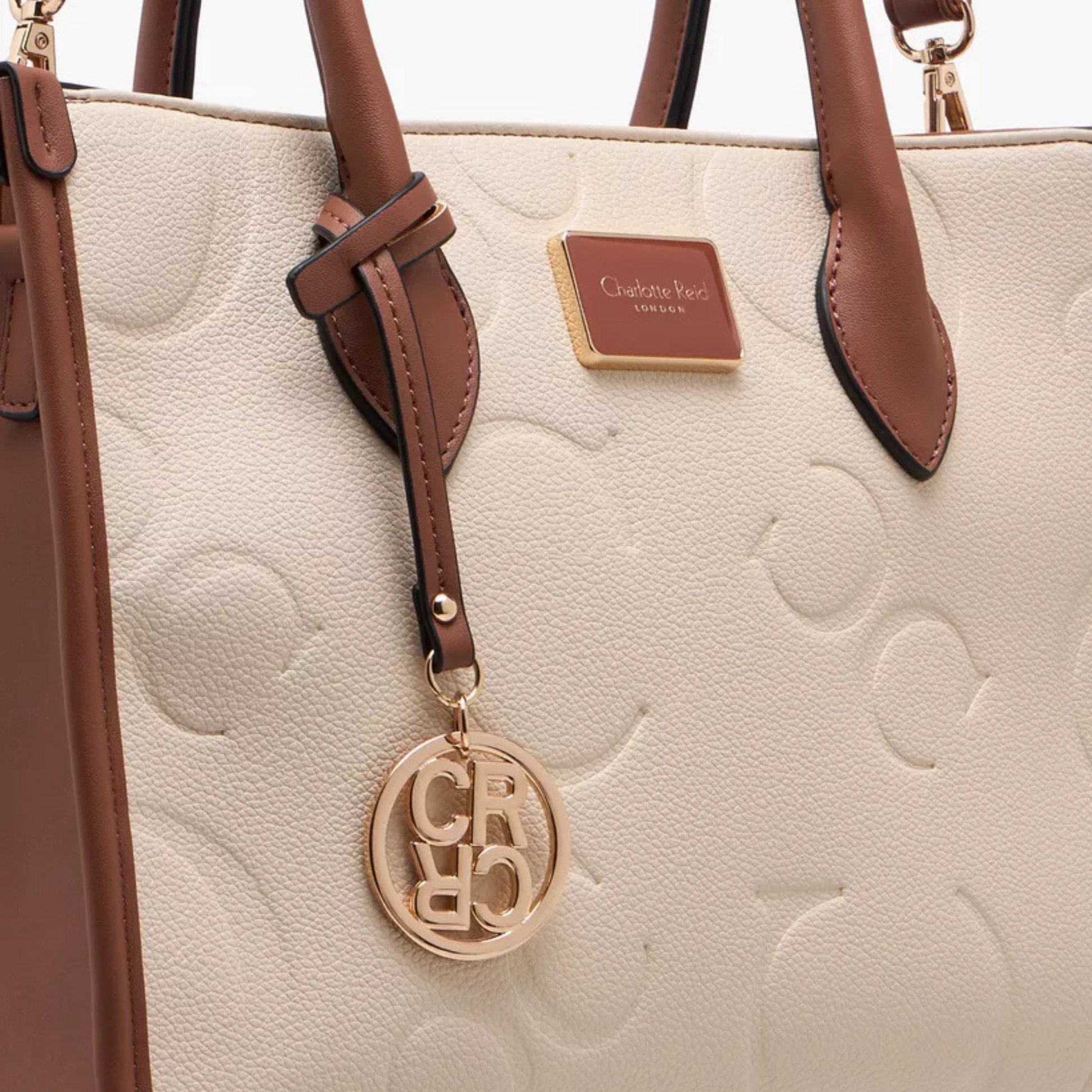 Elegant embossed beige tote bag. Adjustable crossbody strap, roomy interior, and phone/key pocket by InStyle Fashion Hong Kong.