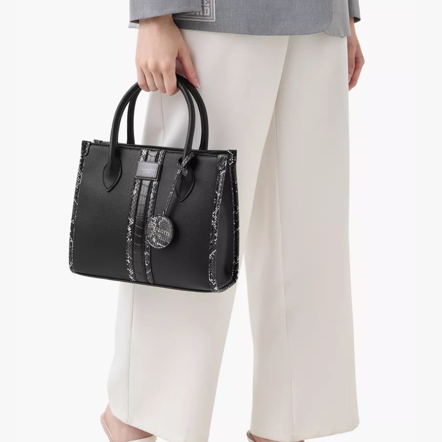 Discover our premium black tote handbag with a sleek structured design, detachable strap, and chic charm—perfect for work, travel, or everyday elegance.