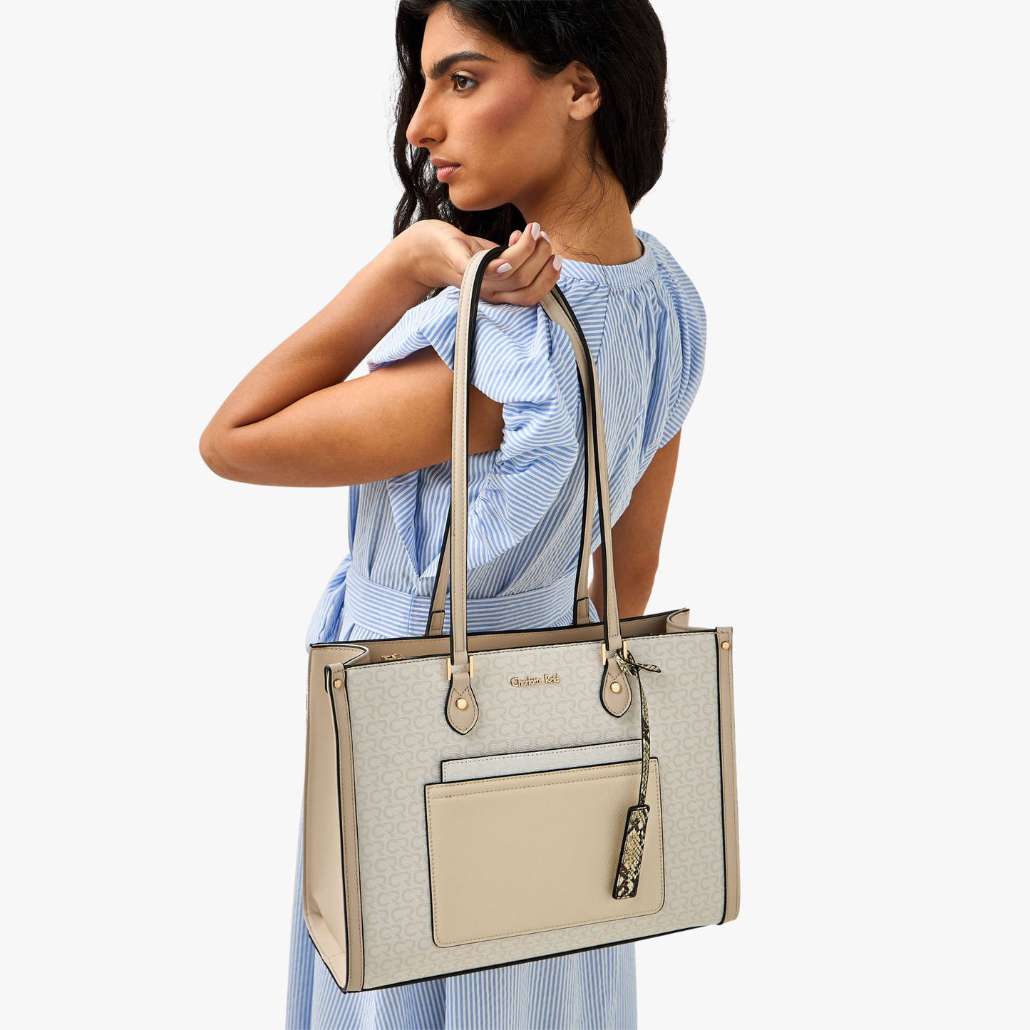 Charlotte Reid elegant beige shoulder handbag with outer pocket, gold branding & spacious design for modern women.