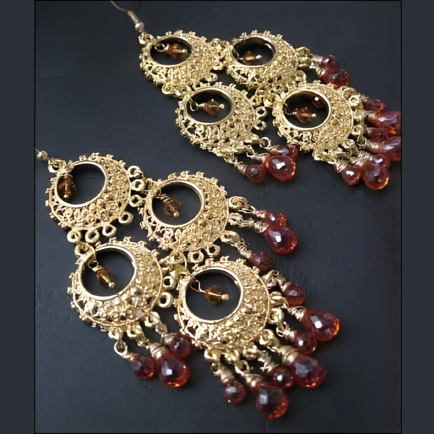 Chandelier earrings, featuring cubic zirconia briolettes wire-wrapped with gold-filled wire, hung from a 14K gold plated pewter piece, from InStyle Fashion HK.