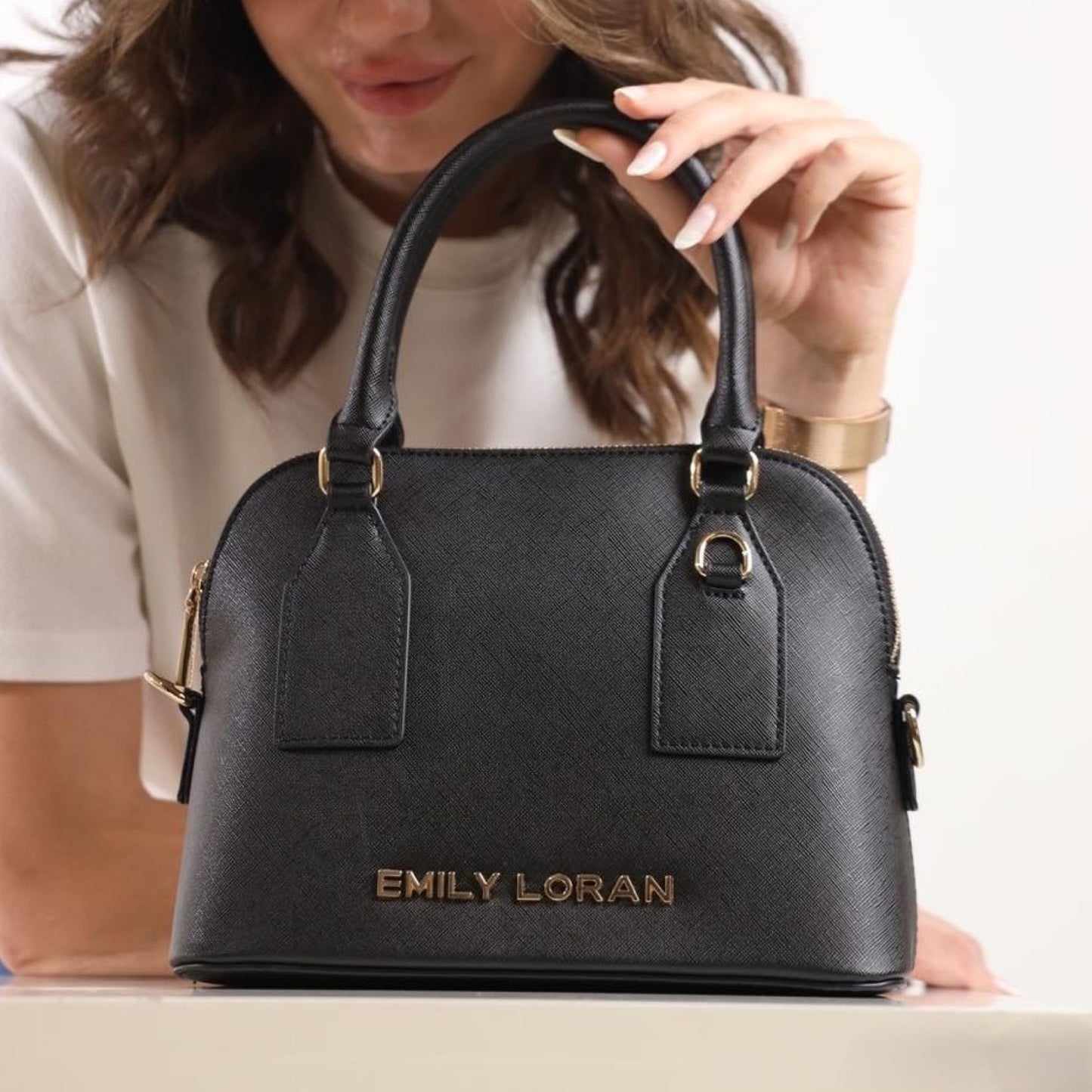 Black double handle handbag with Emily Loran logo and matching removable adjustable long strap.