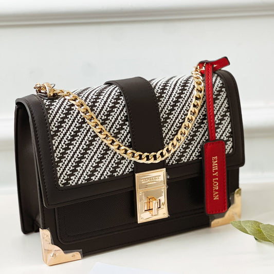 Designer handbag with gold chain, black and white pattern, and red tag on a light background from InStyle Fashion HK.