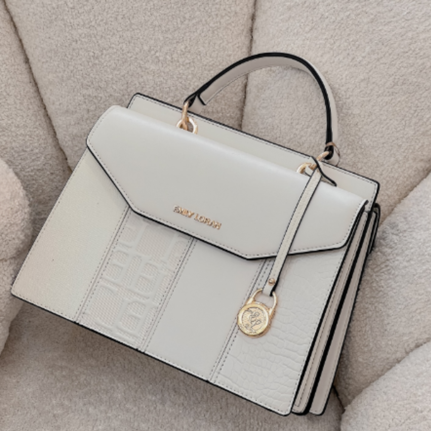 Satchel bag featuring a dual compartment with flaps and magnetic closure, top grab handle,  additional long removable strap.