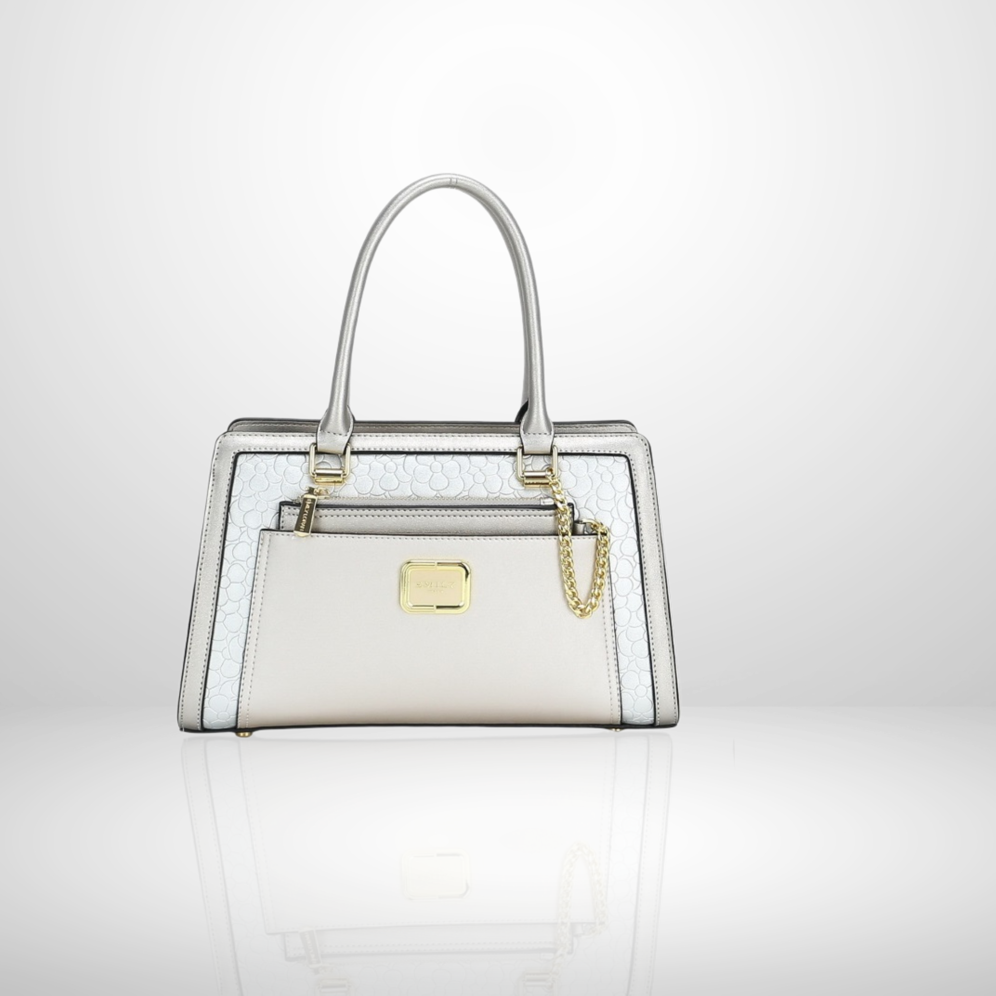 Structured handbags in silver with metallic accents and decorative chains on reflective background
