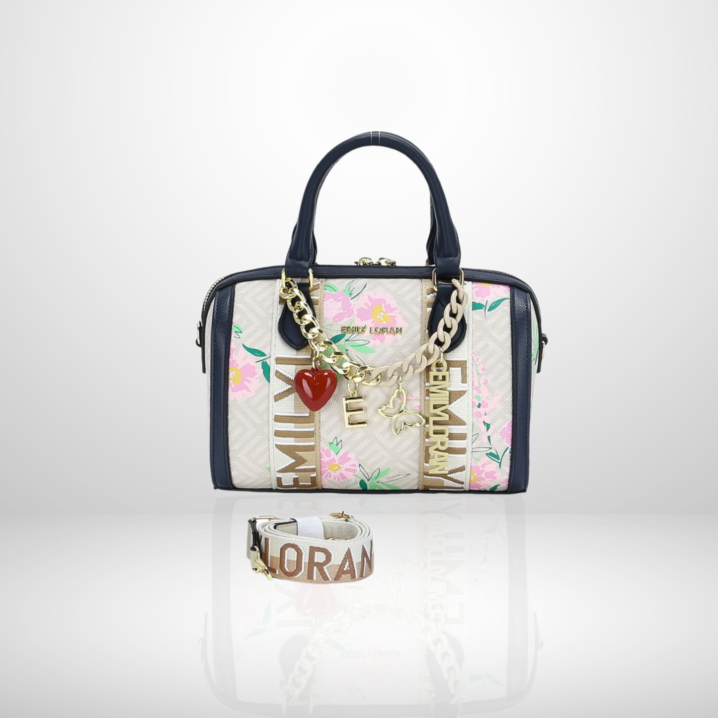 Handbag with floral design and charm, accompanied by a bracelet on a white background