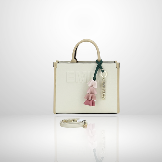 Elegant women's structured tote bag with embossed front logo, floral tassel keychain charm, top handles, and detachable shoulder strap, available in beige.