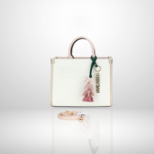 Elegant women's structured tote bag with embossed front logo, floral tassel keychain charm, top handles, and detachable shoulder strap, available in pink.