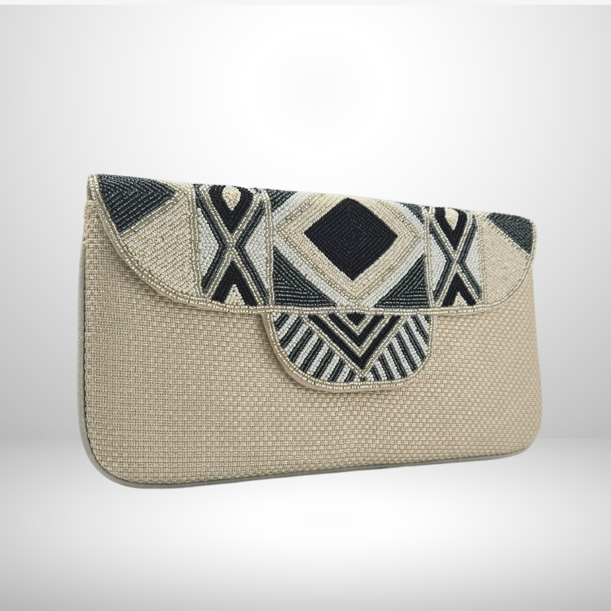 Cream clutch bag with geometric black and white pattern on a light gray background