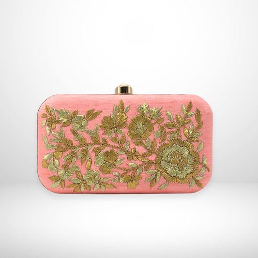 Pink clutch bag with gold floral embroidery on a white background