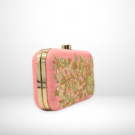 Pink clutch bag with gold embroidery on a white background
