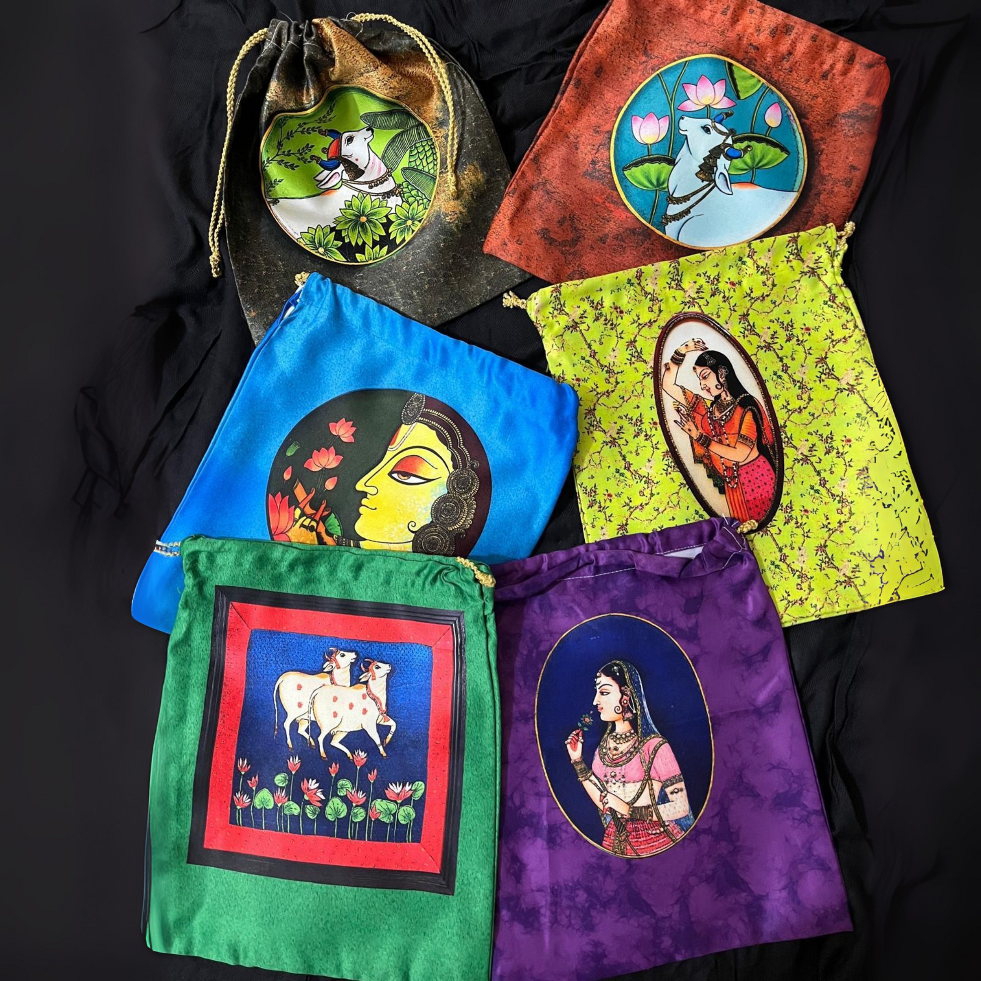 Set of colorful drawstring bags with artistic designs on a black background