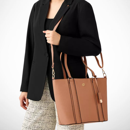 Person holding a brown handbag with a visible brand logo on a white background from InStyle Fashion HK