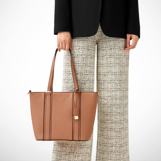 Person holding a brown tote bag with a plain background from Instyle Fashion HK